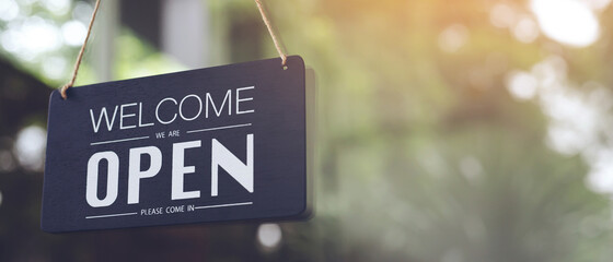 Welcome open sign on shop door. Text on cafe front or restaurant hang on door at entrance. vintage...