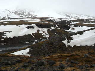 Hiking in the dark and dramatic nature of Iceland's volcanoes, mountains, fjords, geysers and waterfalls