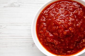 Homemade Tomato Salsa on a white wooden background, top view. Flat lay, overhead, from above. Copy space.