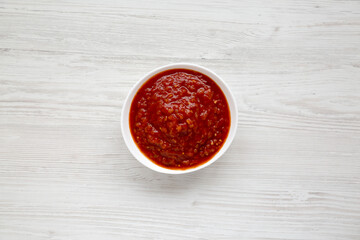 Homemade Tomato Salsa on a white wooden table, top view. Flat lay, overhead, from above.