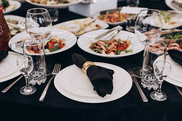Сatering table with food and glass stemware at restaurant before party 