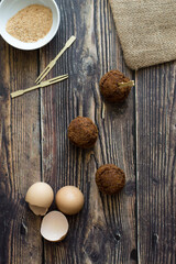 Meatball with potatoes. Wooden background and brown towel.