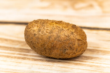fresh potatoes on a wooden background.