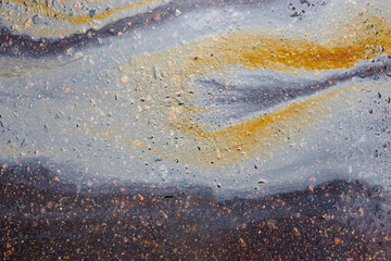 Oil slick on the asphalt road background
