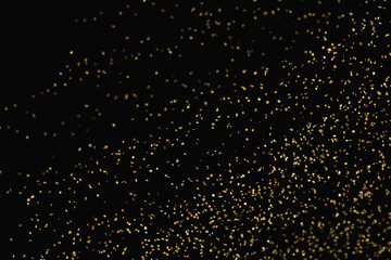 gold abstract pattern glitter stardust sparkling lights grunge on black.