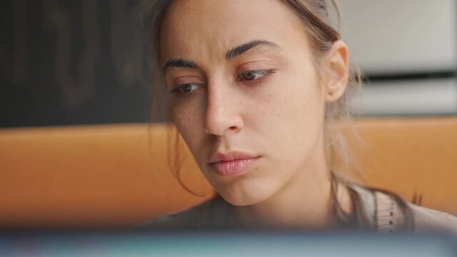 closeup woman working at laptop. female freelancer looking at laptop screen and listen music