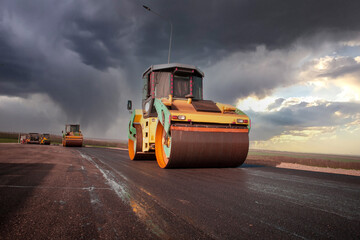 Large view on the road rollers working on the new road construction site