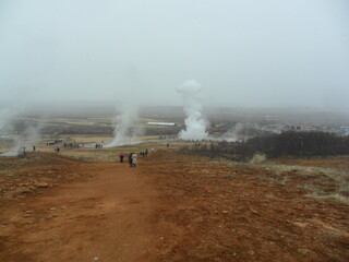 Hiking in the wild and dramatic landscapes of Iceland's snowy mountains, volcanoes, geysers, waterfalls and hot springs