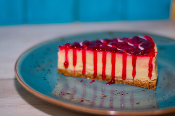 Cake in blue porcelain plate, raspberry chheschake	
