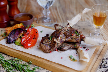 Juicy delicious ribeye or tomahawk steak on the bone with baked potatoes, spices and herbs.