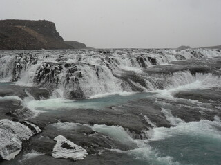 Hiking in the wild and dramatic landscapes of Iceland's snowy mountains, volcanoes, geysers, waterfalls and hot springs