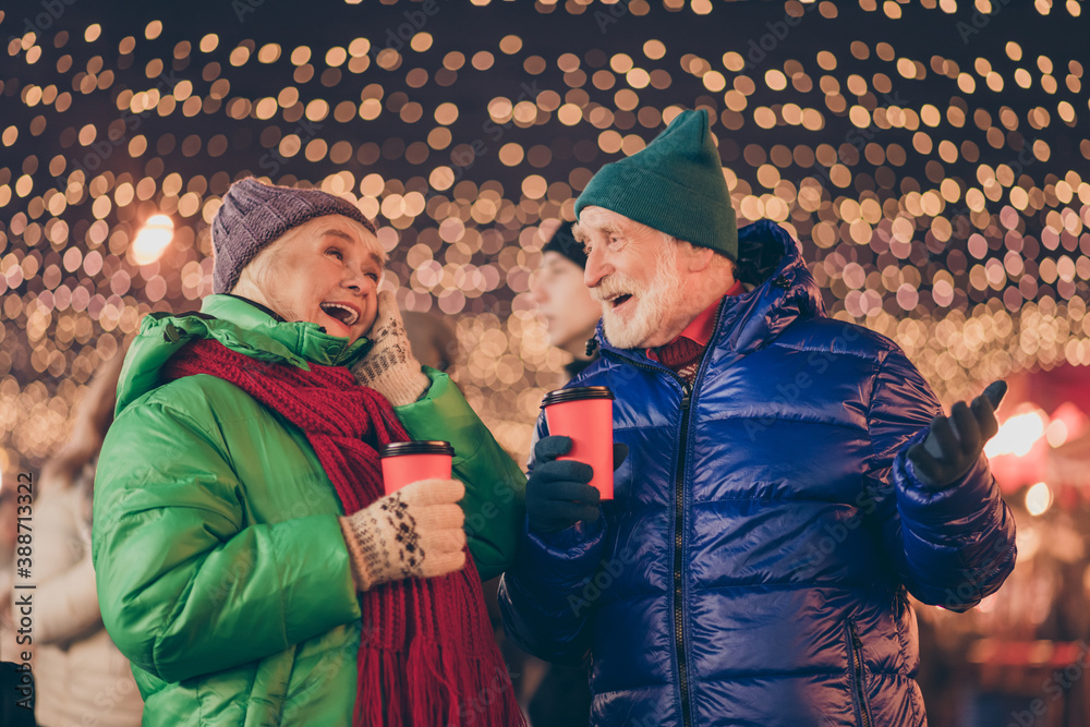 Sticker White grey hair dream two old people woman man have x-mas christmas date speak talk funny jokes hold takeout beverage eggnog mug under lights outdoors