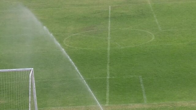 Watering and maintenance of football field lawn
