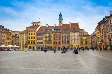 Fototapeta na wymiar Watercolor drawing of Warsaw Old Town Market Place Square with colourful buildings and Bronze monument of Mermaid, Poland