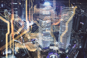 Double exposure of technology theme hologram and cityscape background. Concept of Hightech.