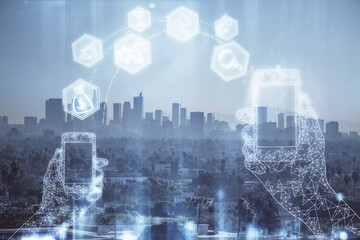 Double exposure of technology theme hologram and cityscape background. Concept of Hightech.