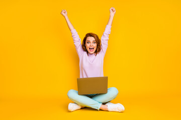 Full length photo of delighted crazy woman sit floor legs crossed folded work laptop win lottery...