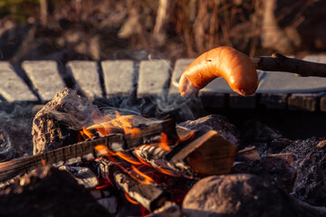 Barbequeing Sausages on a Stick on Campfire