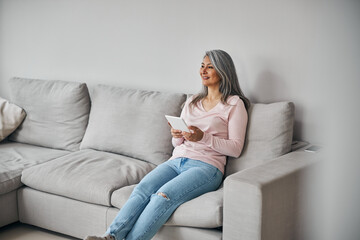 Obraz premium Charming elegant female laughing and resting at home