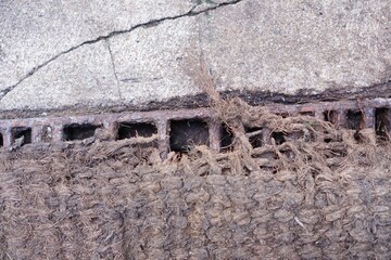 Drain grate channel on footpath concrete.
