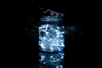 strip of Christmas lights closed inside a glass jar
