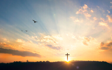 Religious concept: Silhouette cross on mountain at sunset background