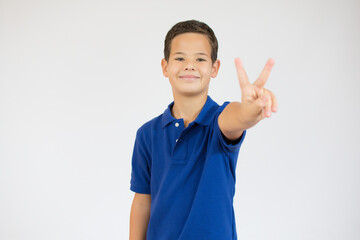 Young caucasian little boy standing against white wall showing and pointing up with fingers number two while smiling confident and happy.