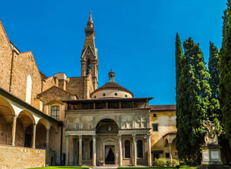 Fototapeta na wymiar Gorgeous close-up view of the Pazzi Chapel in the cloister of the Basilica di Santa Croce in Florence, Italy. It has an arched portal topped by a loggia with decorative elements as a grand entryway.
