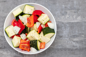 fresh vegetables in cubes in the white bowl