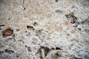 Surface of cracked cement, see red old brick inside