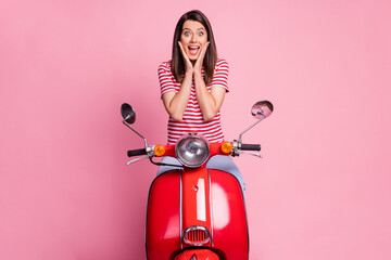 Photo portrait of female driver sitting on red motorcycle touching cheeks happily isolated on...