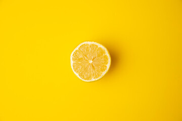 open lemon fruit on yellow background