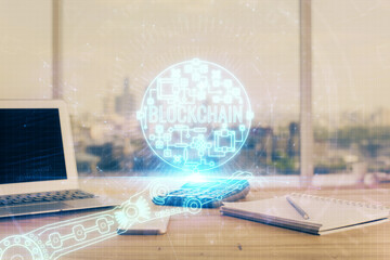Double exposure of blockchain theme hologram and table with computer background. Concept of bitcoin...
