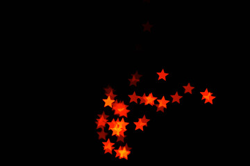 light orange star light effect isolated overlay glitter texture on black.