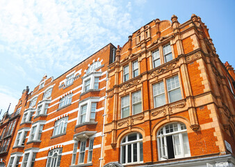 Fototapeta na wymiar Red brick buildings in Long Acre Street at City of Westminster. London, England UK. 