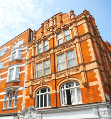Fototapeta premium London, UK. Red brick buildings in Long Acre Street at City of Westminster. 