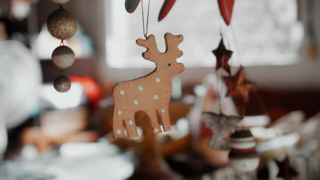 wooden Christmas toys deer hanging on a thread in the house