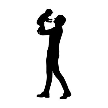 Silhouette happy father holding newborn baby in air