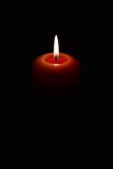 burning candle on a black background. flame of fire