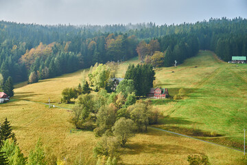 Fototapeta na wymiar Sunlit hilly pasture during autumn 