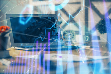 Forex market chart hologram and personal computer background. Multi exposure. Concept of investment.