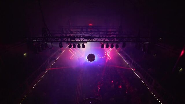 Multicolor light rays at a trance concert, People partying to psychedelic dance music, at a nightclub, in Amsterdam, Netherlands