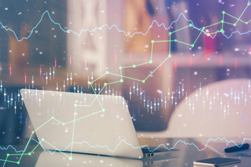 Financial graph colorful drawing and table with computer on background. Multi exposure. Concept of international markets.