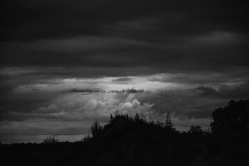 Black and white photography, dark clouds and sky, hill, landscape 