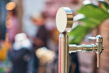 beer tap outdoors blurred background