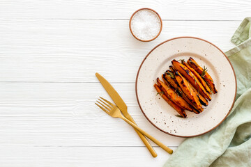 Top view of sweet potato fries with herbs and spices