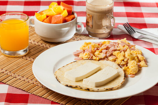 Arepa for breakfast, cheese and scrambled egg, a traditional Colombian dish.