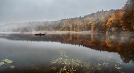 Fototapeta na wymiar Calm autumn morning over the lake with copy space