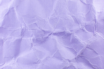 Crumpled purple paper background. Real macro battered texture. Close up photo.