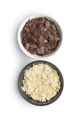 Grated white and dark chocolate. Chocolate flakes in bowls isolated on white background.